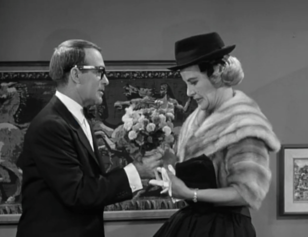 Sally's date accidentally hands her his hat (which she wears in this still) instead of the flowers he brought for her. (Screen capture by Lindsey for TMP)