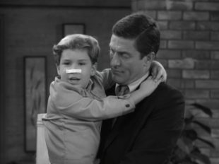 Ritchie pretends he's been punched in the nose after hearing that his dad punched Jerry in the nose. (Screen capture by Lindsey for TMP)