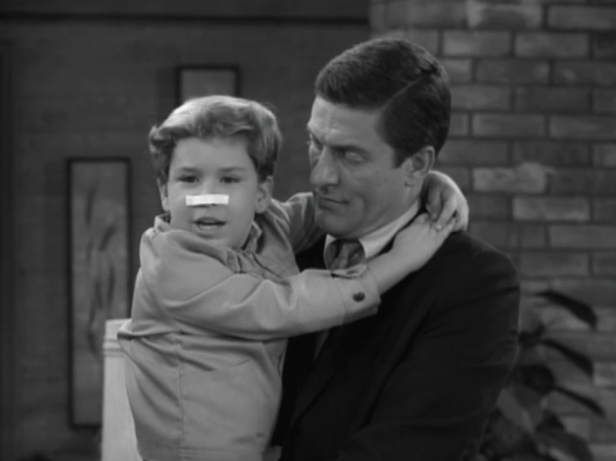 Ritchie pretends he's been punched in the nose after hearing that his dad punched Jerry in the nose. (Screen capture by Lindsey for TMP)