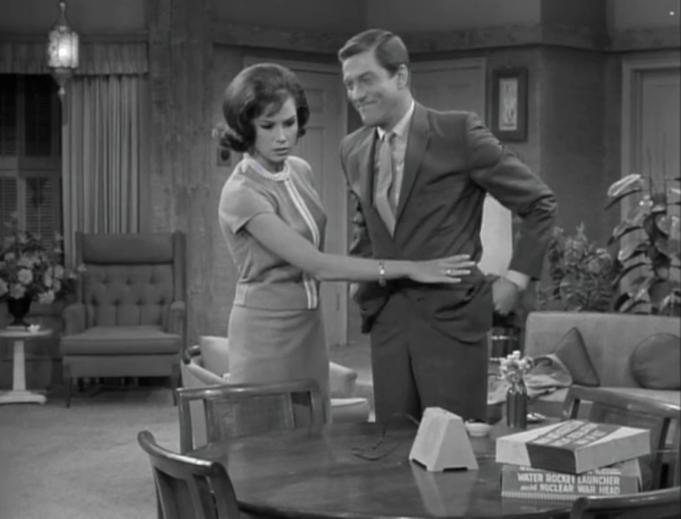 Laura wants Rob to turn the intercom off... until she hears her own name mentioned. (Screen capture by Lindsey for TMP)