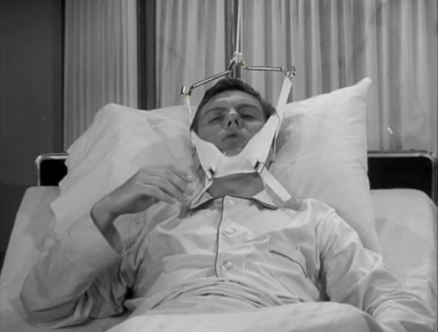 Poor Rob, stuck in the hospital with some sort of recovery/torture contraption strapped to his head! (Screen capture by Lindsey for TMP)