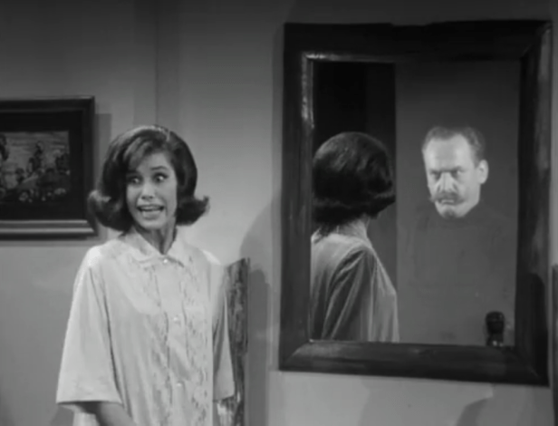 Laura is shocked to see a face other than her own staring back at her in the mirror! (Screen capture by Lindsey for TMP)