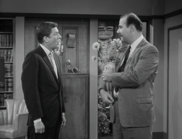 Alan's companies are like the flowers in the vase -- some are healthier than others, and the one that pays Buddy and Sally isn't doing so well. (Screen capture by Lindsey for TMP)