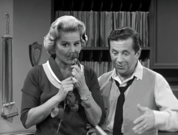 Confusion strikes in the office when Sally finds a rose from an unknown sender in her desk. (Screen capture by Lindsey for TMP)