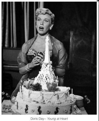 Doris Day and a cake, for 1954's Young at Heart. She sold cakes before she shared the screen with them! (Image via Pinterest)