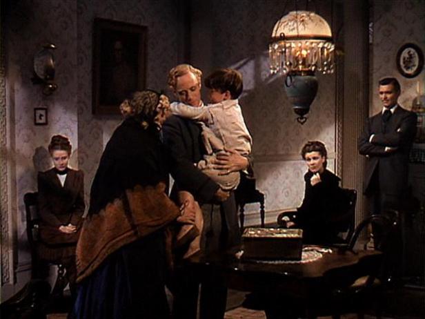 Mickey Kuhn is held by on-screen father Leslie Howard in one of his two scenes. (Image via vivienleigh.com)