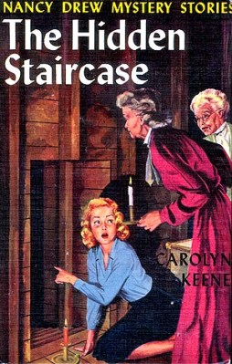 The cover of the 1959 edition of the book shows Nancy's discovery of a hidden passageway, accompanied by Rosemary and Flora. (Image via nancydrewsleuth.com)